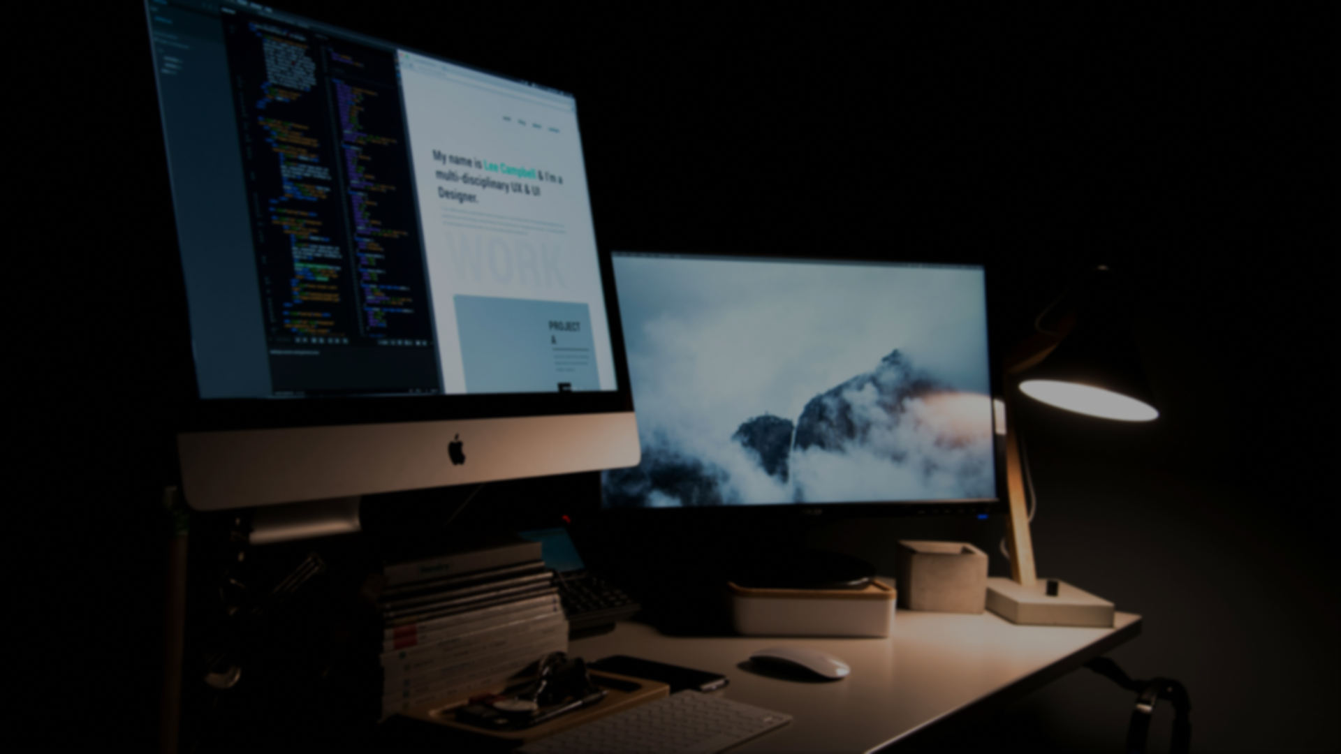 Professional workspace with dual monitors showing development environment
